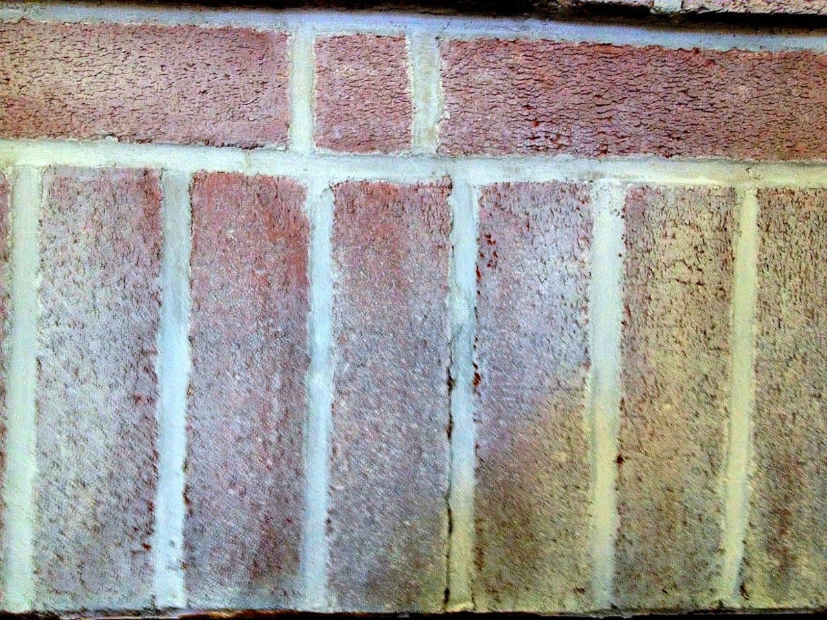 use white paint and water to stipple the brick with whitewash