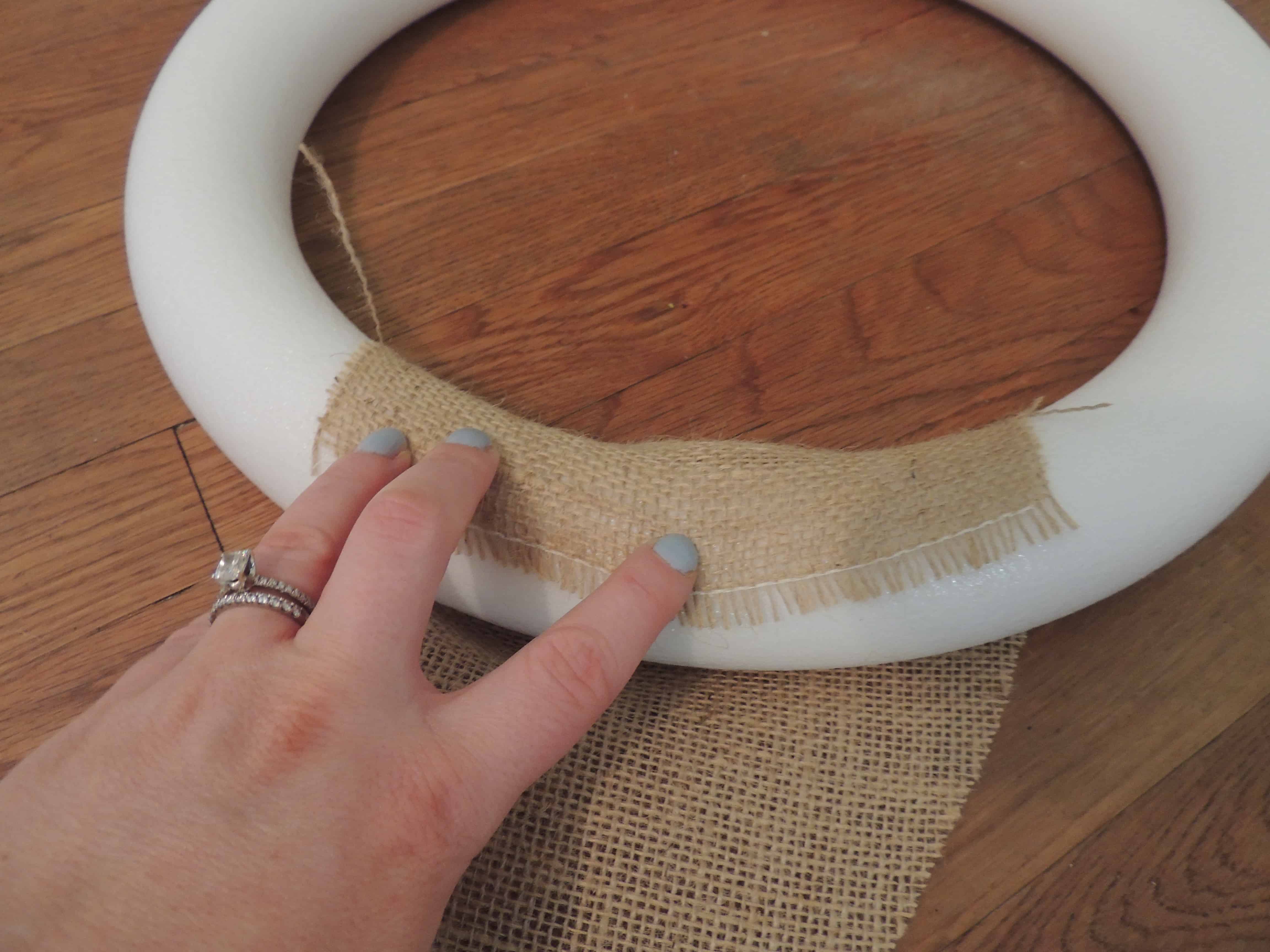 Use hot glue to secure the base pieces of burlap to the foam wreath ring