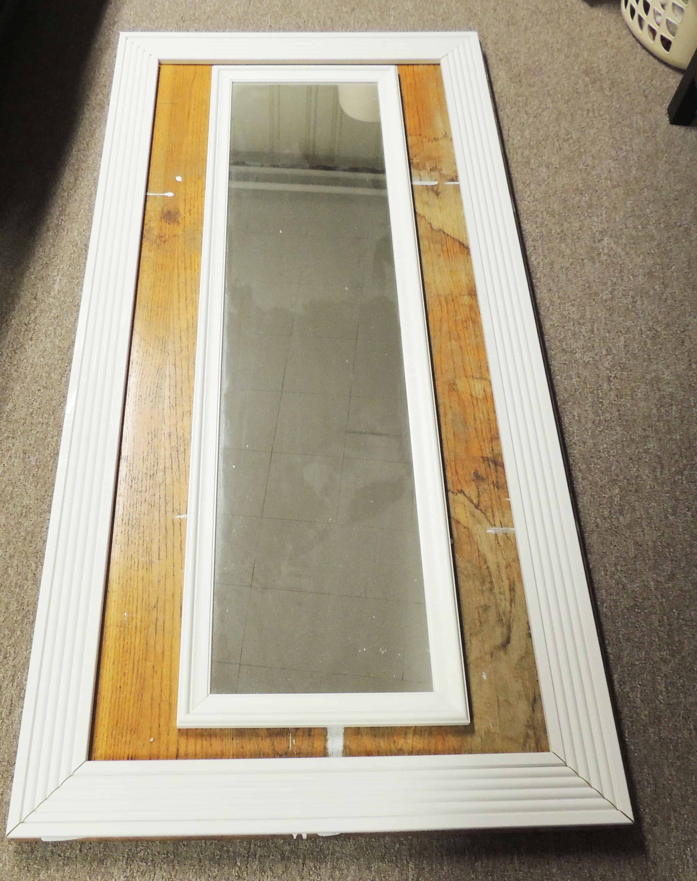 DIY Floor-mirror: $5 mirror set on wooden table with white wooden frame