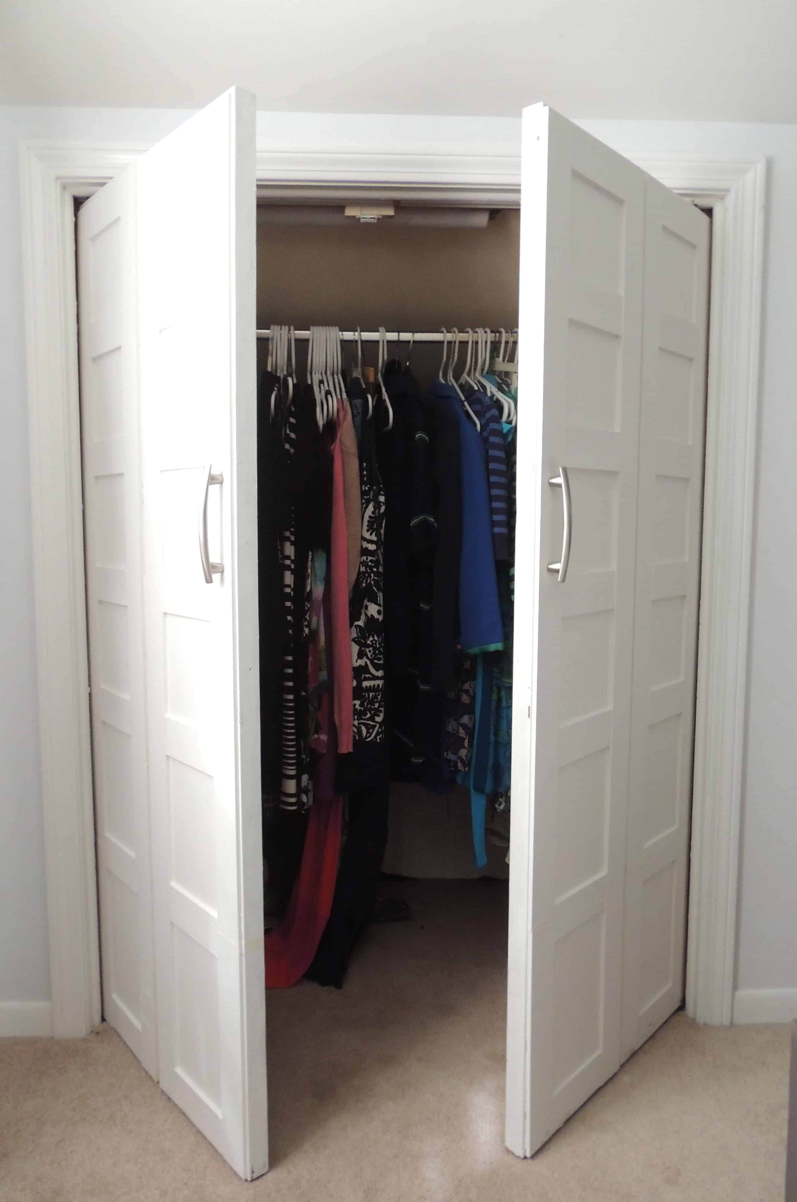 White bifold closet doors, slightly opened, now swinging out instead of folding