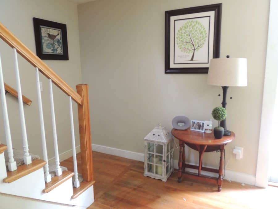 Bottom of staircase with walls painted Benjamin Moore Manchester Tan