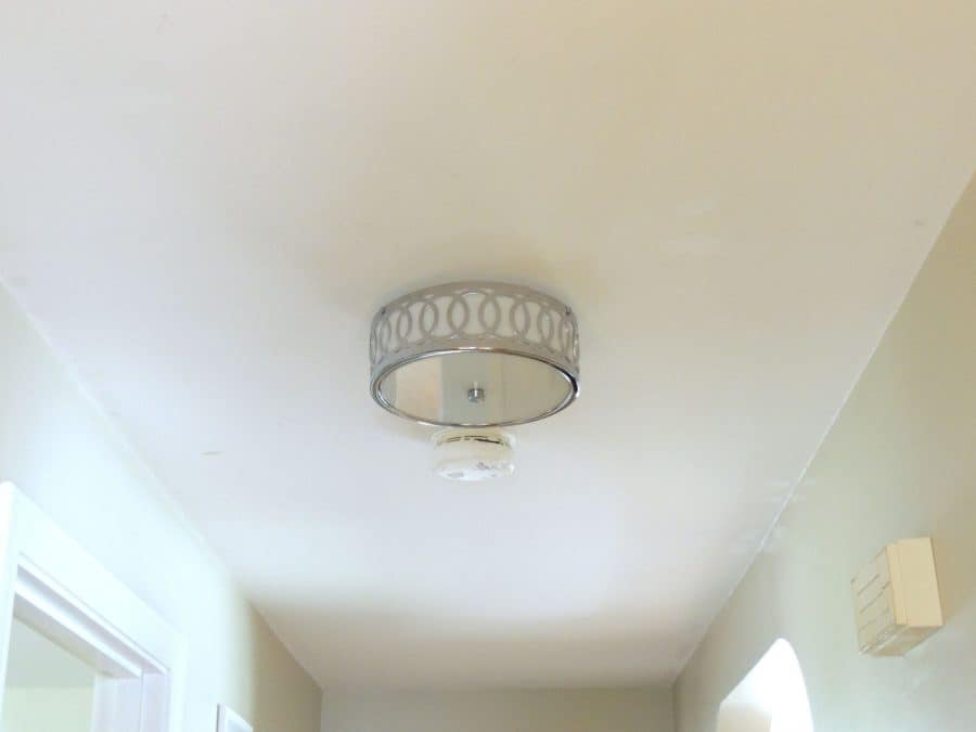 Completed installation of silver light fixture in hallway