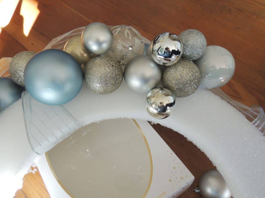 A close-up of the arrangement of the different sizes of ornaments on the foam form, currently resting on empty boxes