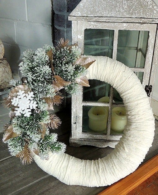 This simple DIY winter wreath is made with yarn and festive winter accents
