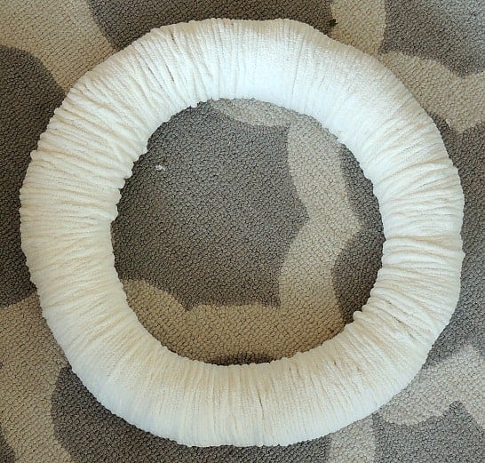 Wrap the whole wreath ring with yarn. I used a soft white fleece yarn for my winter wreath