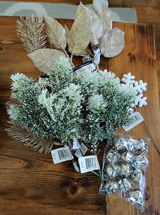 Decorate your winter wreath with festive accent pieces like snow-covered pine branches, snowflake ornaments, and bells