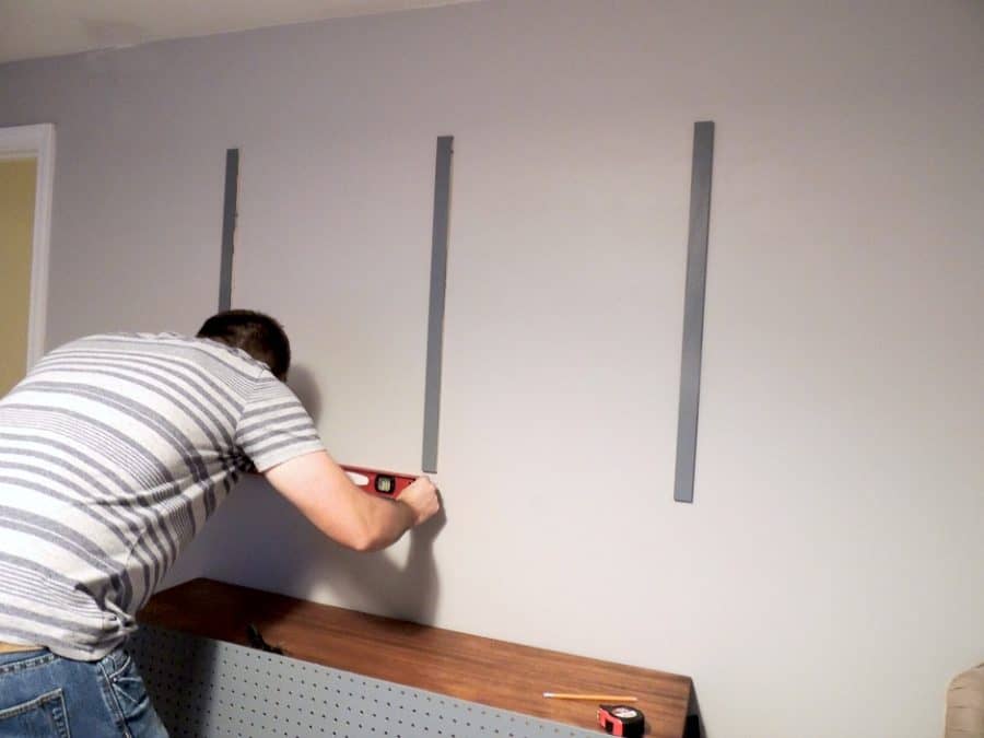 A person using a level on a wall 