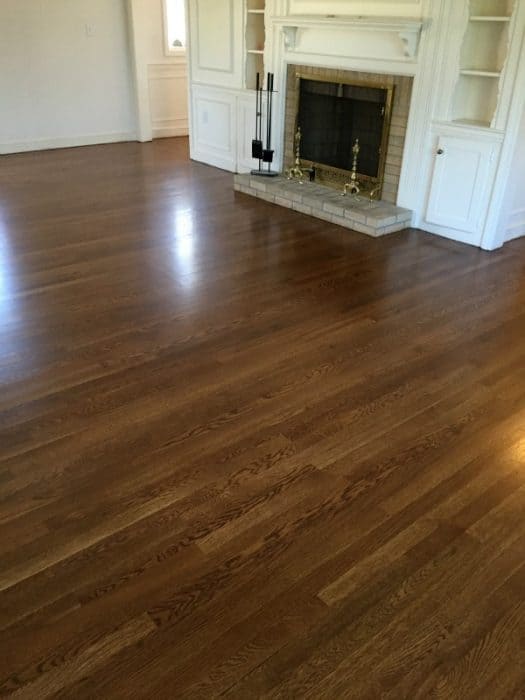 A fireplace and refinished hardwood floors