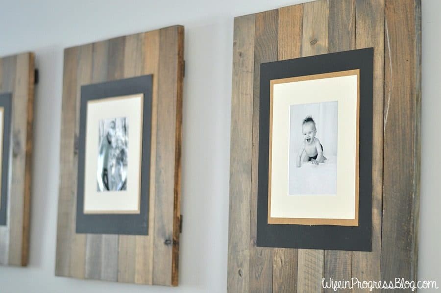 DIY picture frames made from scrap wood with family photos attached.