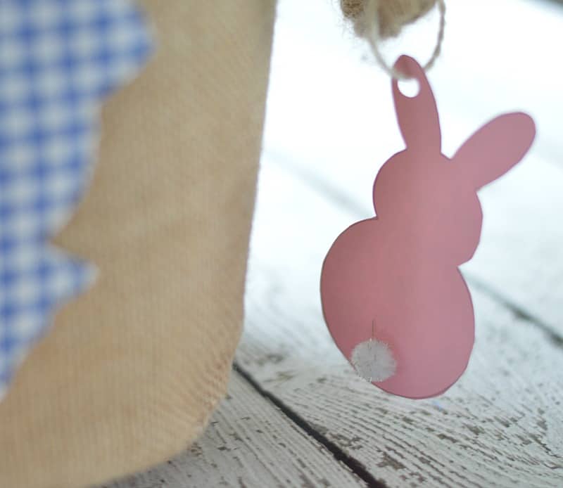 Pink paper Easter bunny with small white pom pom tail