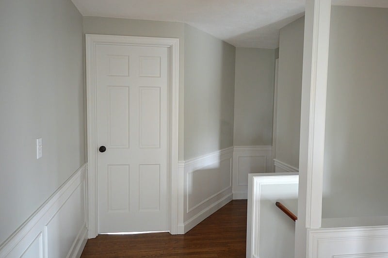 upstairs hallway with doors and wainscoting painted benjamin moore decorator's white