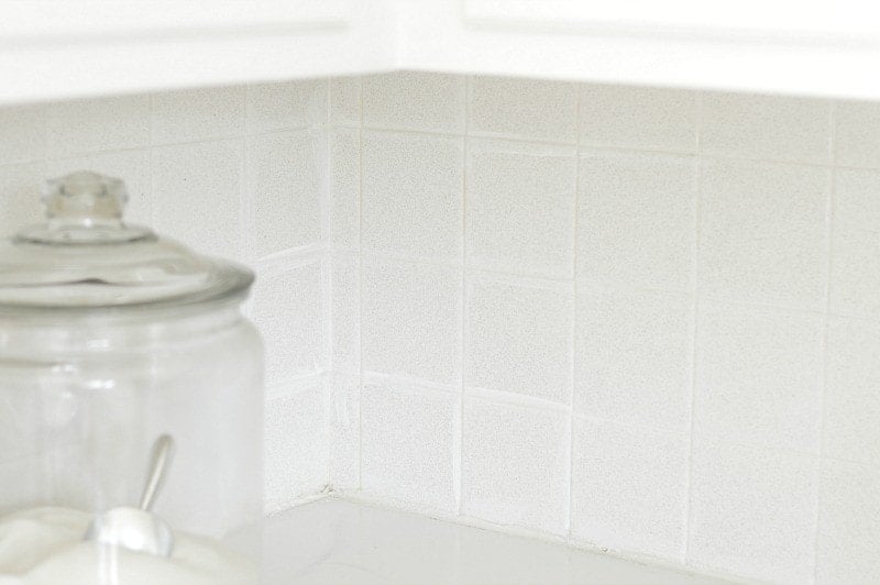 Using white acrylic paint helps to restore grout to it's original bright white