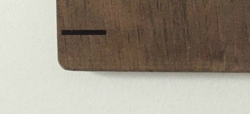 Sanded edge of wooden board for life size ruler