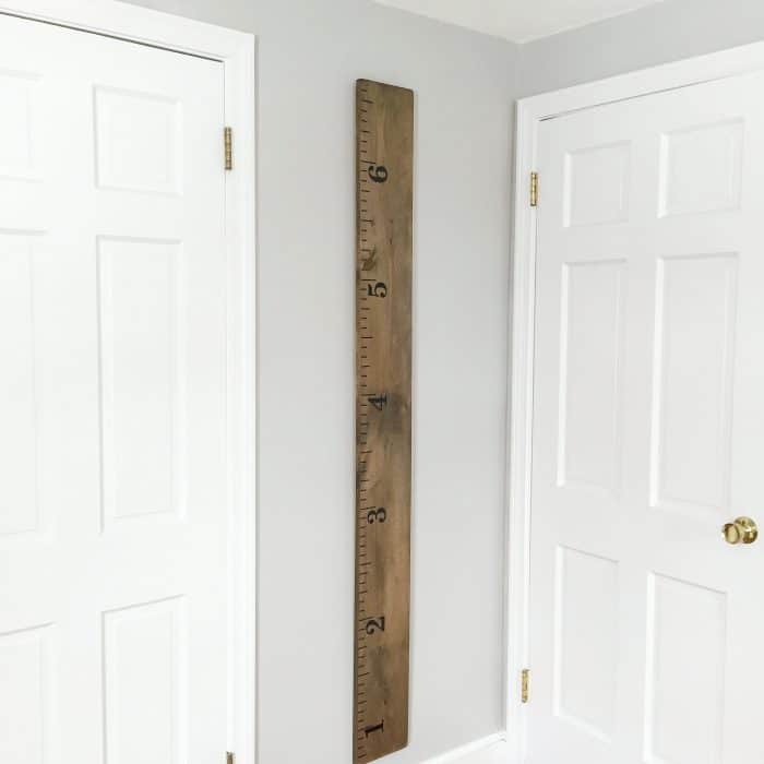 Wooden life size ruler hanging on wall