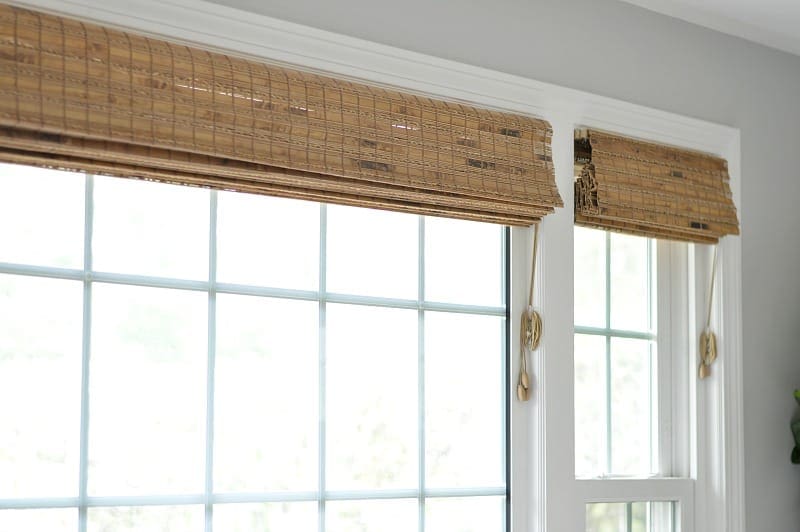 Rolled-up wooden blinds in two windows