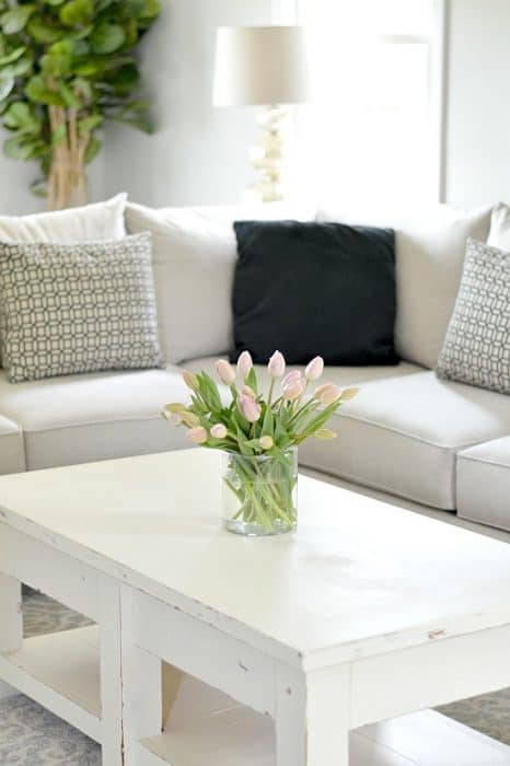 There's some beautiful rustic elements in this neutral living room by WifeinProgressBlog.com