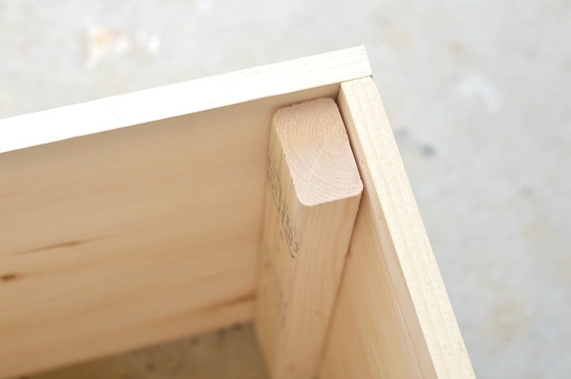 The corner of the wood planter after the planks are nailed together