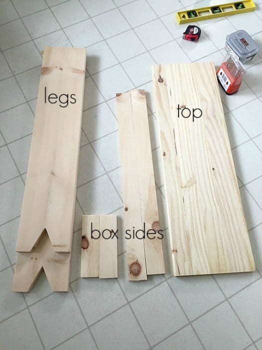 Wood pieces used to create DIY console table - 2 legs, a broad top plank and narrower pieces of wood used for the box and sides