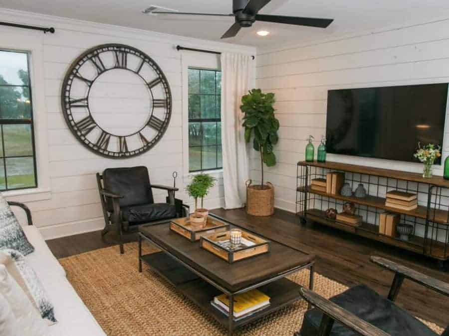 Fixer Upper living room with large clock, industrial furniture and shiplap walls