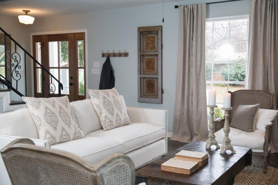 Blue Gray walls and off white couch in the farmhouse style living room