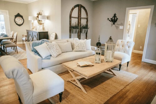 Joanna Gaines designed living room with neutral couch and light wood furniture
