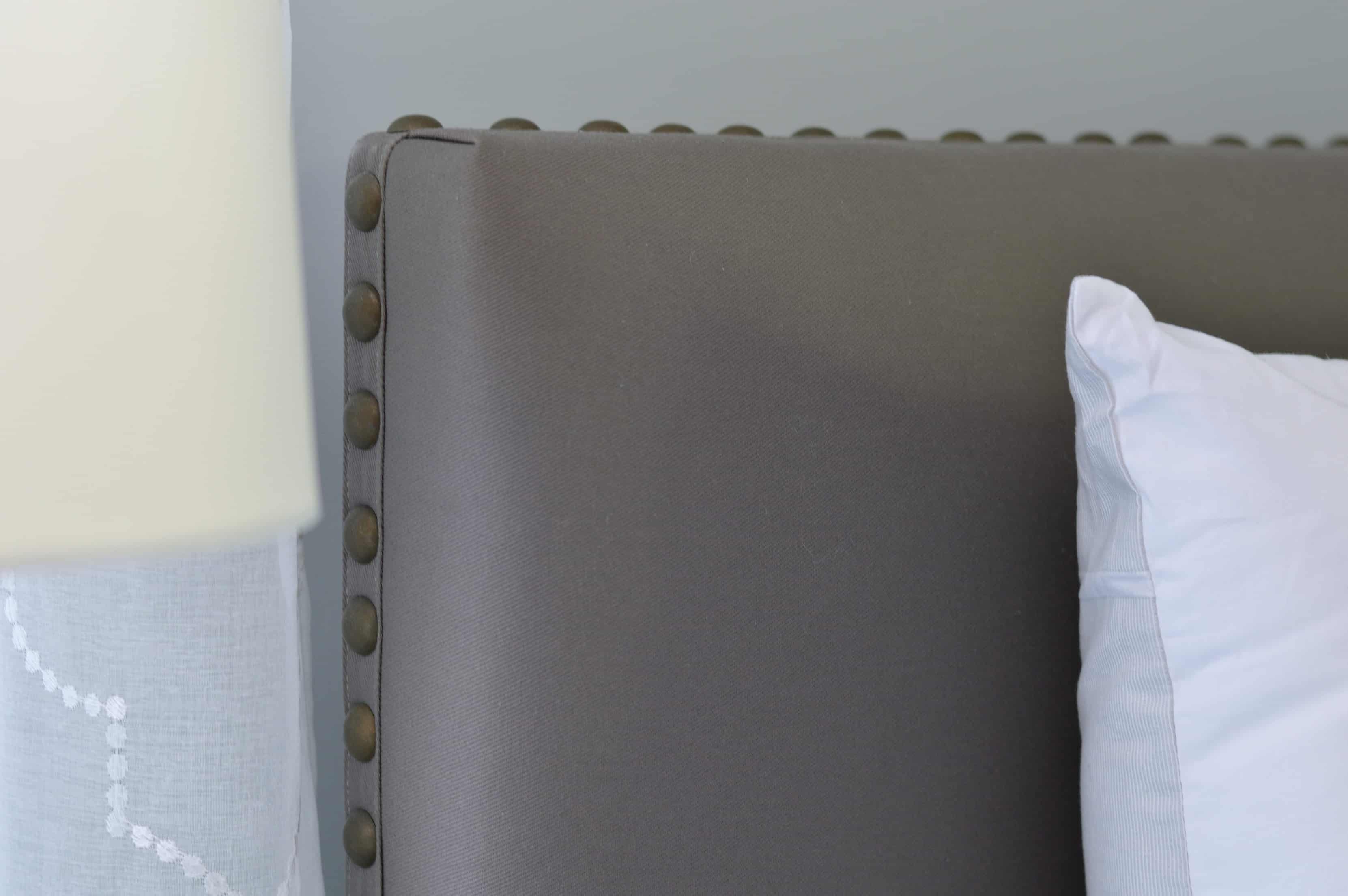 Beautiful grey bedroom makeover featuring this stunning nailhead trim bed | WIfeinProgressBlog.com