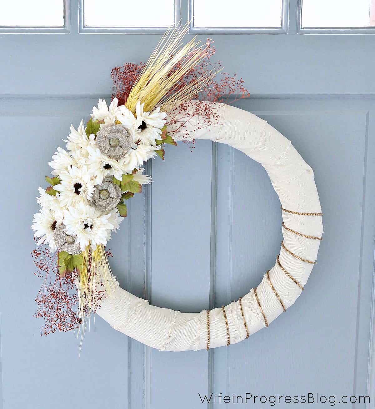 Close up of the DIY fall burlap wreath hanging on a door