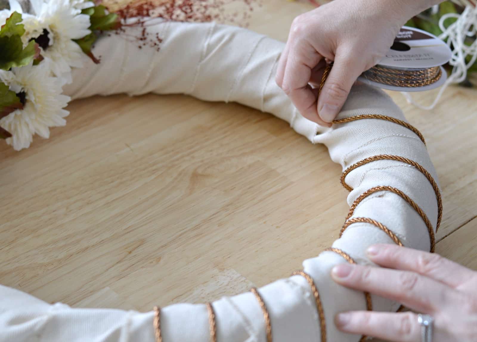 wrapping copper string around the wreath