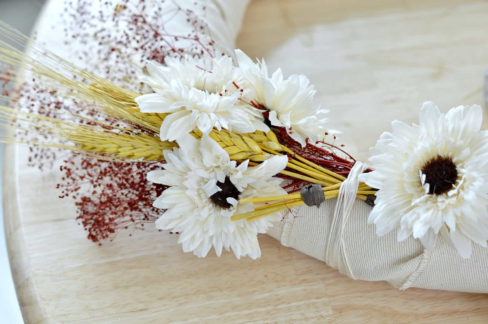 tie wheat to the wreath using twine or string
