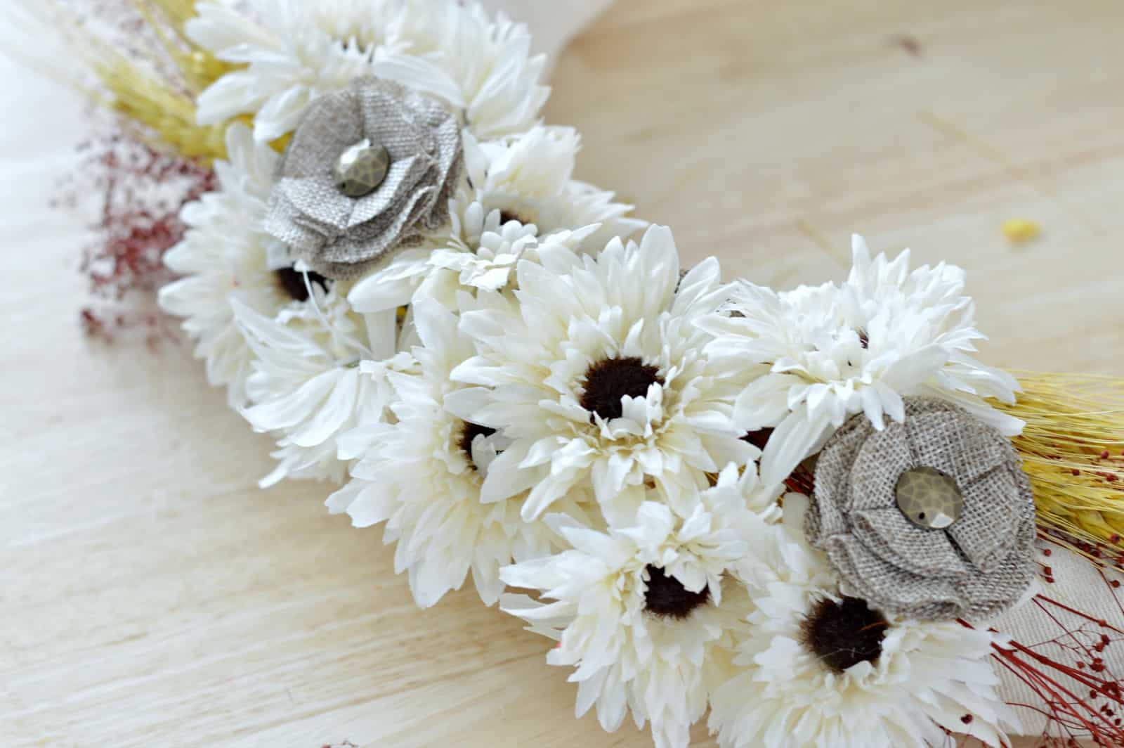close up of faux flowers glued to the fall wreath