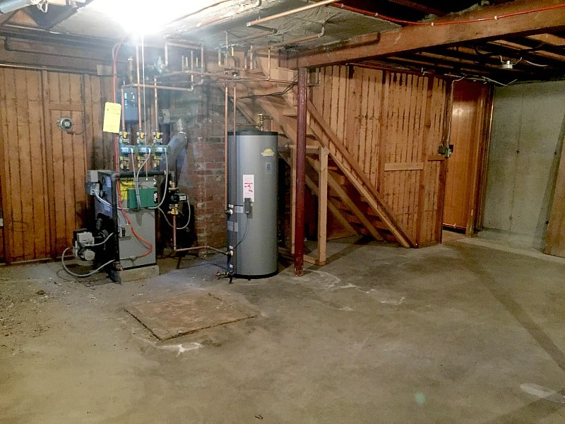The water heater and furnace in the basement, under the staircase