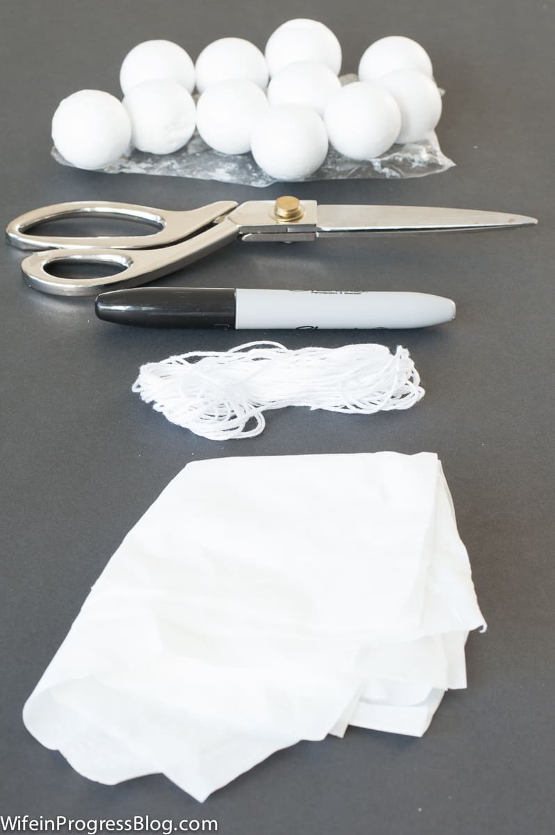 The materials used: styrofoam balls, scissors, permanent marker, white string and tissue paper
