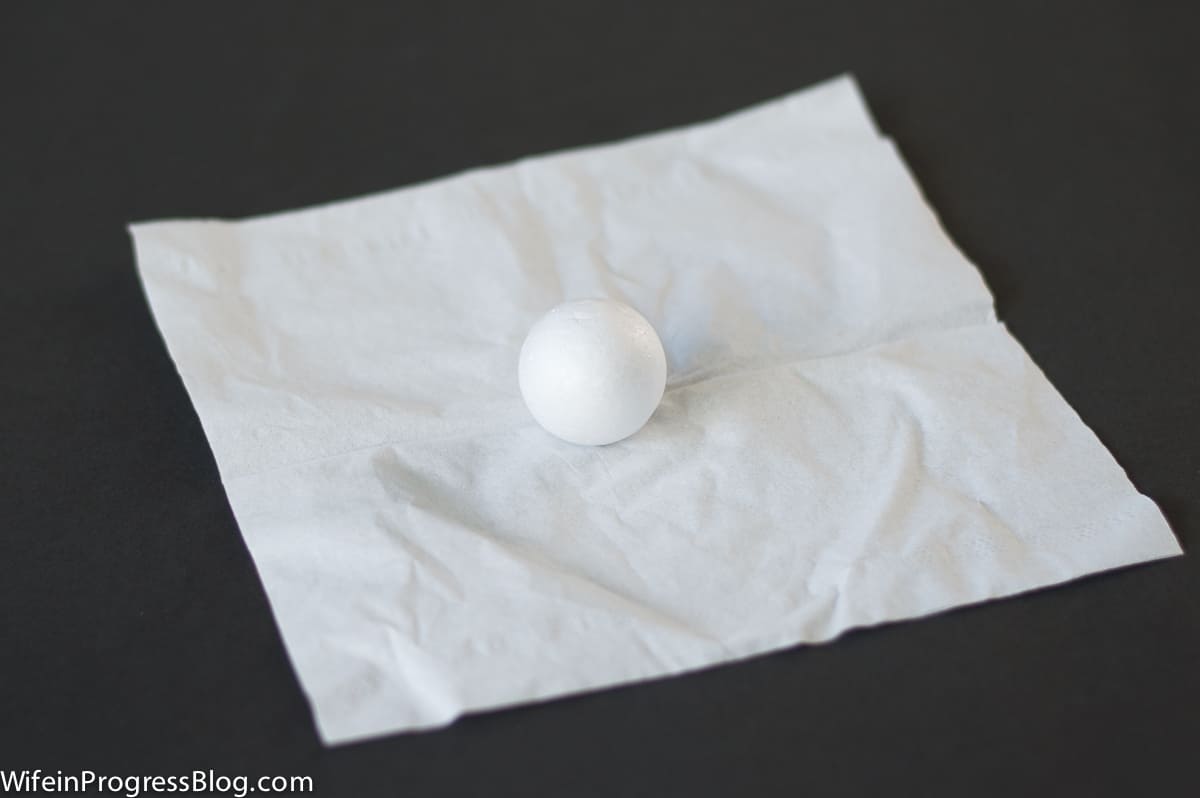 A square of tissue paper and one small, styrofoam ball