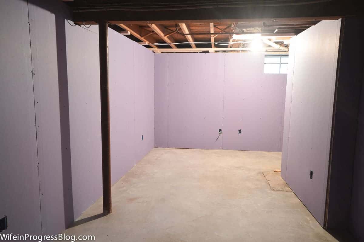New drywall installed to replace old, wood paneling in the basement, and drop ceiling removed