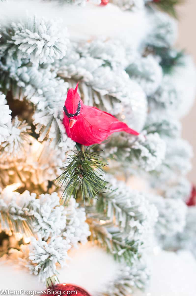 A red cardinal perched on the Christmas tree is a unique decoration idea