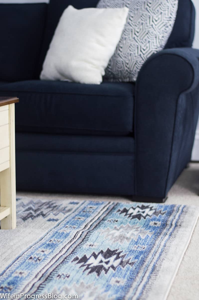 A living room with a couch and a rug