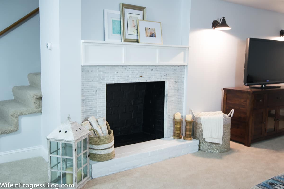 Carrara marble tiled fireplace as part of extensive basement remodel. Stunning!