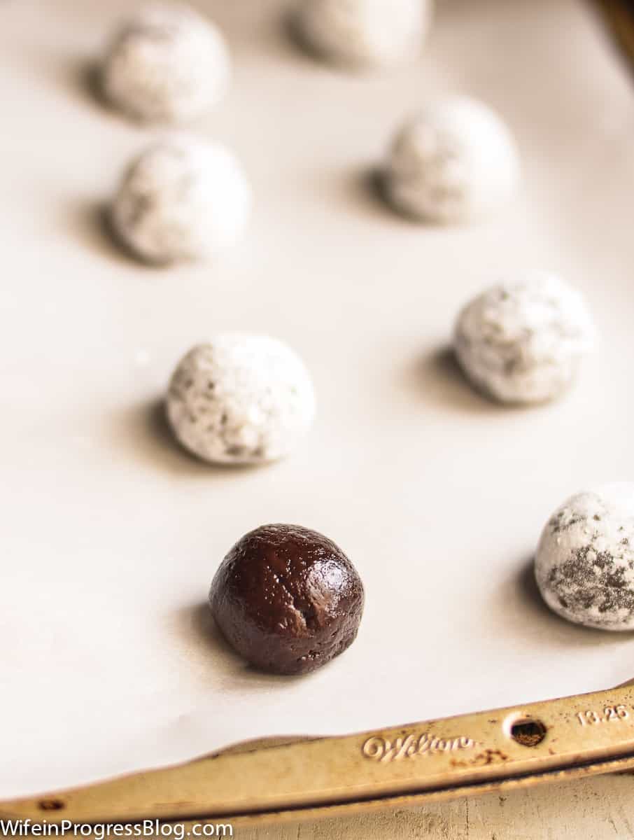 Roll the crinkle cookie dough into small balls and coat in powdered sugar