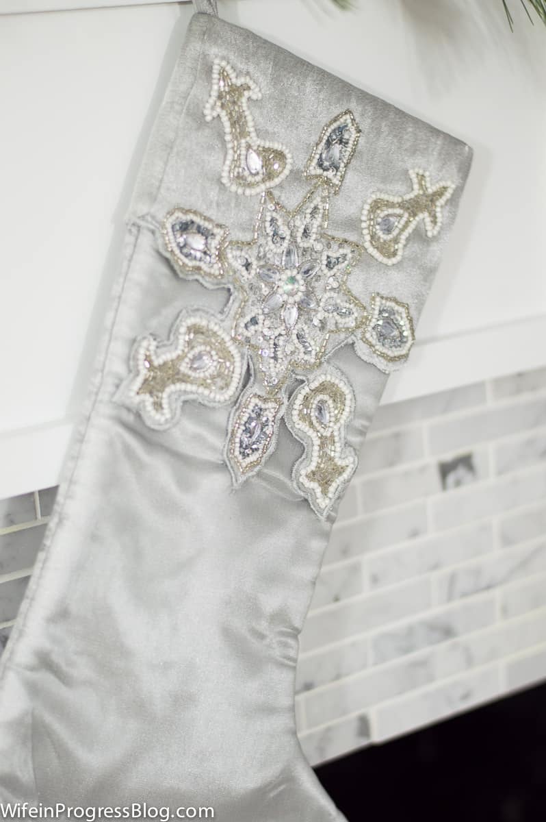 Grey stocking with intricate silver and white patterns on the top half