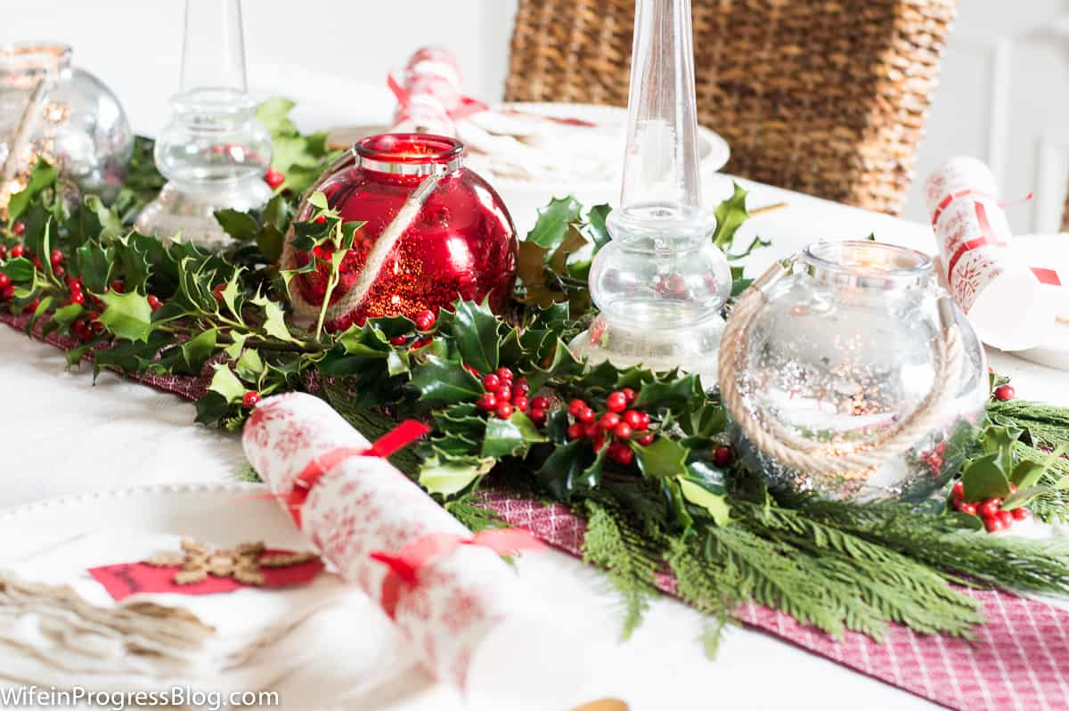 Christmas table decorations don't have to break the budget - a little holly, some greenery and some mercury glass is all you need!