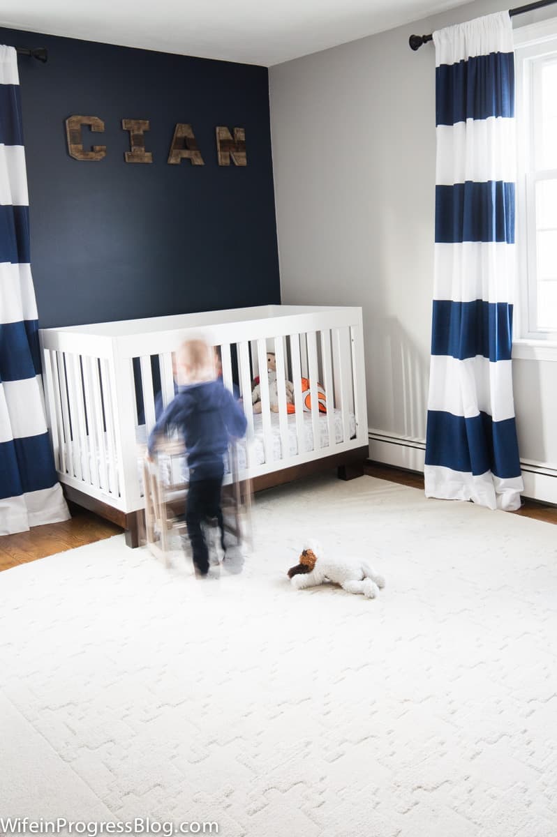 Sherwin Williams Naval accent wall in a coastal themed little boy's nursery