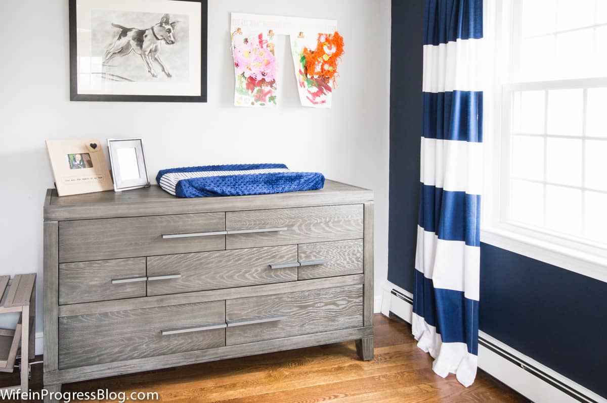 Stonington gray toddler bedroom walls with navy and white striped curtains.