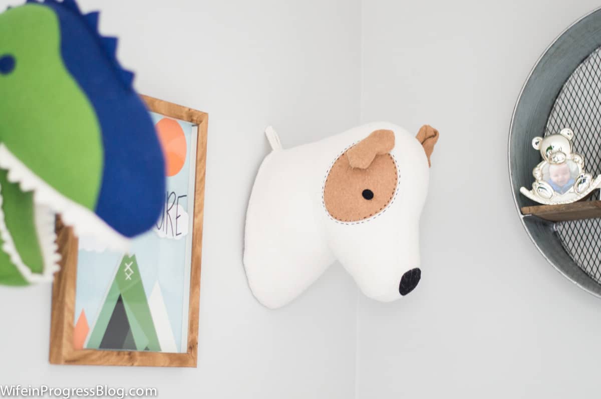 A stuffed animal mounted on the wall, near wall art