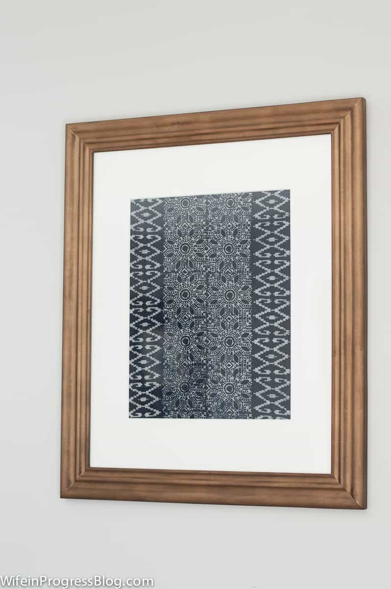One of the framed textile art pieces, with a busy and intricate blue and white pattern