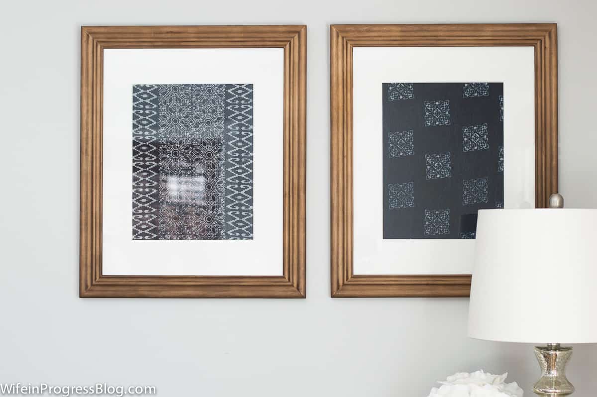 The pair of framed textile prints now placed on the grey wall above the blue console table