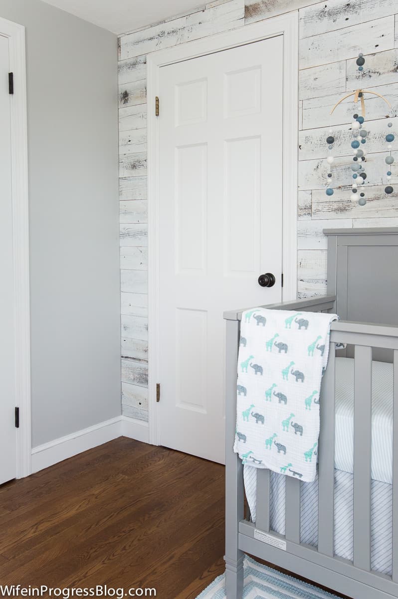 Little boys nursery with Stonington Gray walls and a whitewashed reclaimed wood accent wall. 