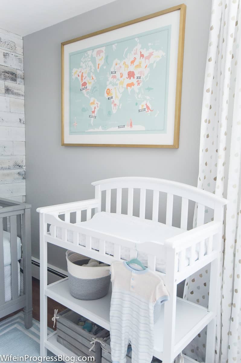 Benjamin Moore Stonington Gray nursery walls with animal map print over a white changing table.