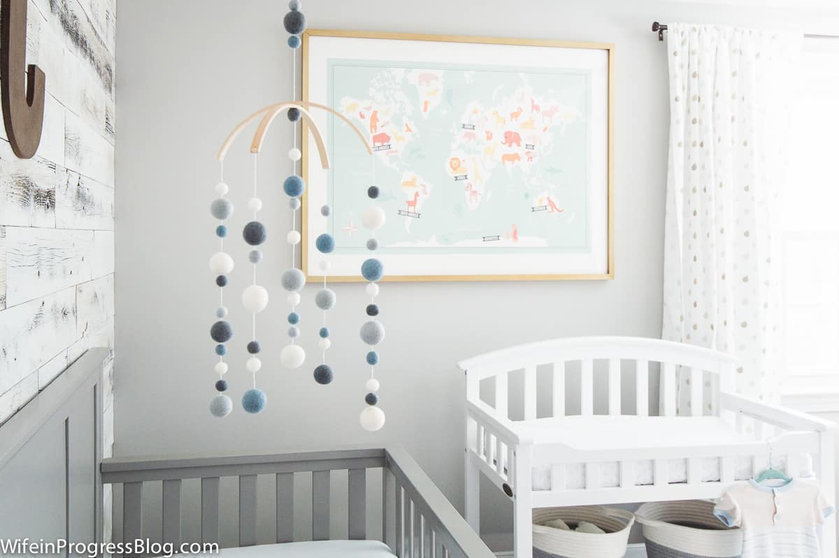 Gray and blue baby boy nursery featuring rustic touches like reclaimed wood accent wall