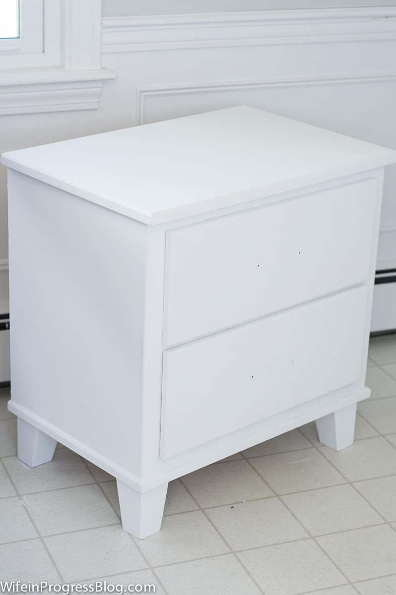 The nightstand, now painted white, before drawer handles are reattached