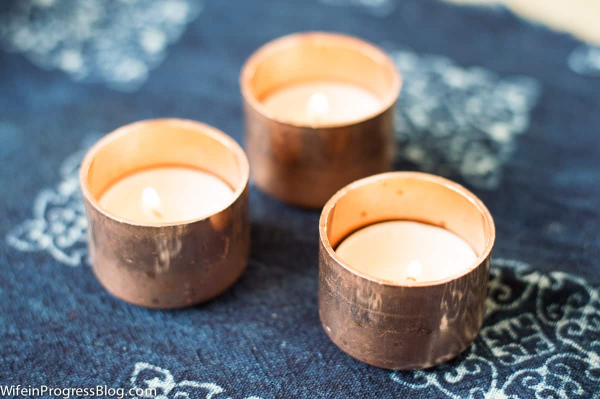 A top view of the tealights in copper end caps on a blue background